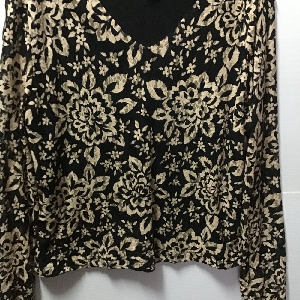 Black background with beige lace overlay